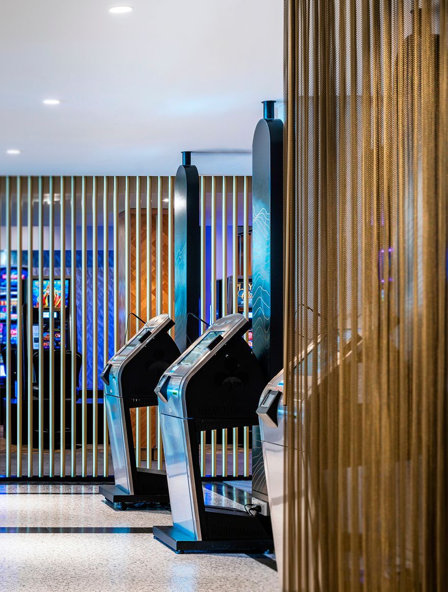 Club sign-in terminals with gold curtain and decorative panels