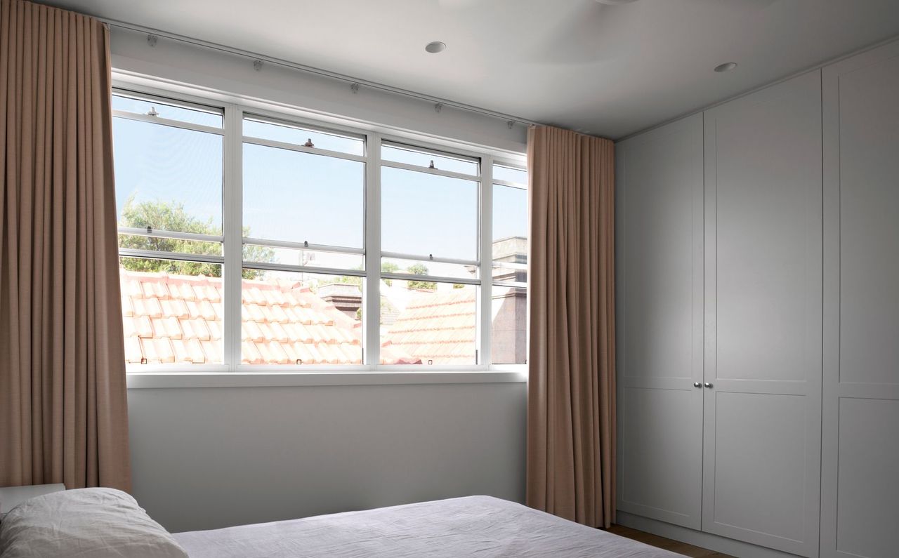 Master bedroom in the contemporary extension overlooking rooftops