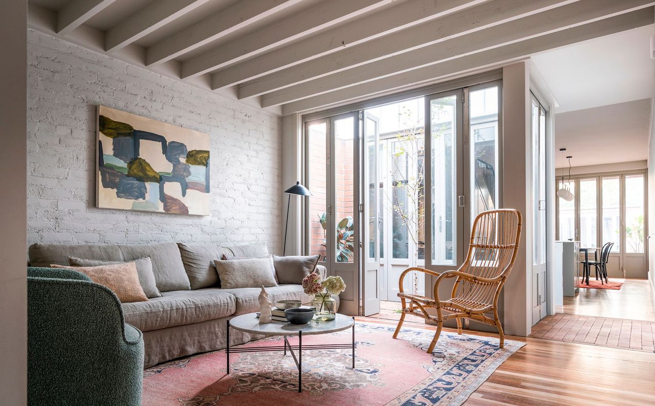 Living room in original cottage space through to small courtyard and extension