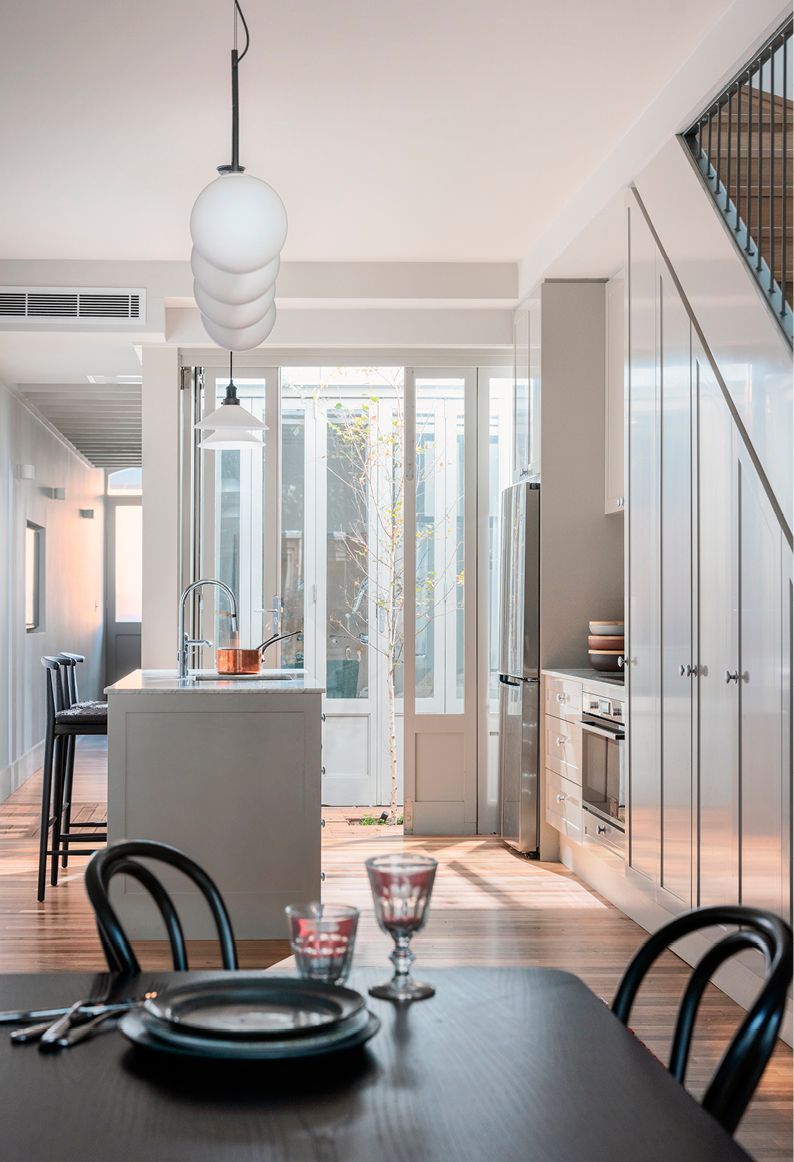 Dining and kitchen looking to small courtyard between original cottage renovation and new extension